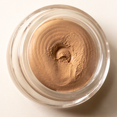 Toned cream in a round jar