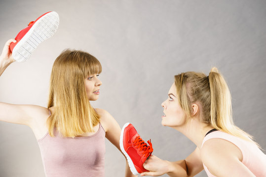 Women fighting with shoes