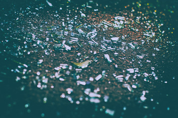 Sharp shards of car glass on the asphalt after car accident