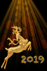 New year 2019 and Cristmas card. Golden deer on the background of golden rays and bokeh. Black background. Place for your text