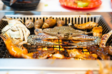 Seafood platter., delicious prawn,squid ,crab ,seashells spit on grill and beach bbq in restaurant