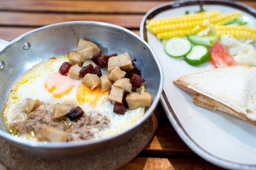 Close up breakfast food in Thai style ,Indochina pan-fried egg with pork and toppings ,salad .Selective focus ,vintage tone