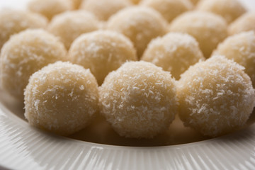 Coconut Sweet Laddoo OR Nariyal Ladduis a Popular Festival food from India. Served over moody background, selective focus