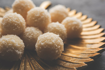 Coconut Sweet Laddoo OR Nariyal Ladduis a Popular Festival food from India. Served over moody background, selective focus