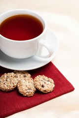 Cup of tea next to cookies