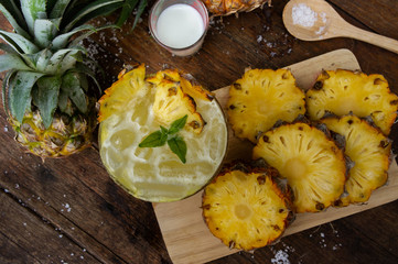 pineapple juice and piece of fruits ready to eat on the wood table