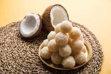 Coconut Sweet Laddoo OR Nariyal Ladduis a Popular Festival food from India. Served over moody background, selective focus