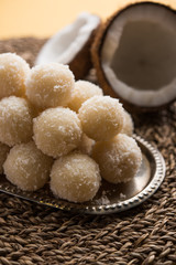 Coconut Sweet Laddoo OR Nariyal Ladduis a Popular Festival food from India. Served over moody background, selective focus