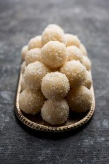 Coconut Sweet Laddoo OR Nariyal Ladduis a Popular Festival food from India. Served over moody background, selective focus