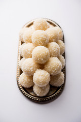Coconut Sweet Laddoo OR Nariyal Ladduis a Popular Festival food from India. Served over moody background, selective focus
