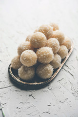 Coconut Sweet Laddoo OR Nariyal Ladduis a Popular Festival food from India. Served over moody background, selective focus