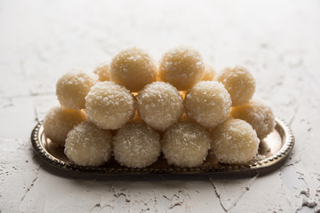 Coconut Sweet Laddoo OR Nariyal Ladduis a Popular Festival food from India. Served over moody background, selective focus