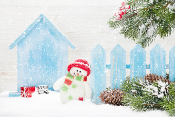 Christmas snowman toy and fir tree branch