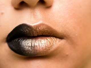 Lips make-up. Beauty high fashion trendy black with gold colour gradient lips makeup sample, sexy...