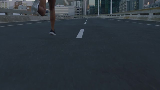 slow motion woman runner legs running on city street jogging exercising fit female athlete training