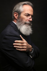 mature male model wearing suit with grey hairstyle and beard