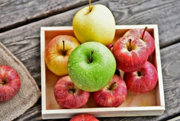 colorful of 3 Type of apple,Gala,Granny Smith,Golden Delicious in wooden box and wooden background.