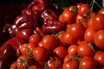 Fresh ripe tomatoes and red peper on the market counter