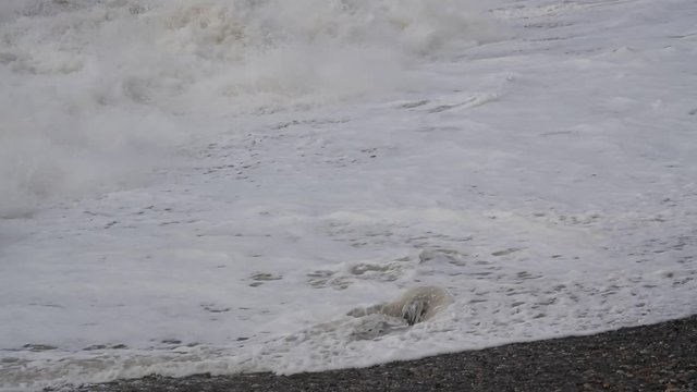 Sea surf. Waves runs on coastal pebble. Georgia, Kvariati