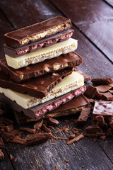 Chocolate bars on table with chocolate tower.