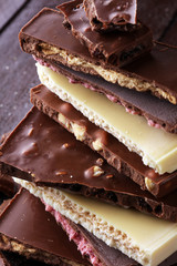 Chocolate bars on table with chocolate tower.