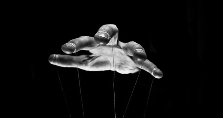 Eerie puppeteer hands controlling you. Manipulation concept - obrazy, fototapety, plakaty