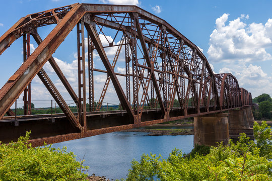 Old rusty truss railroad bridge over the Red River on the border of Texas and Oklahoma