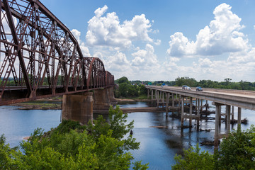 Vehicles passing the border between the states of Texas and Oklahoma ove rthe Red River bridge