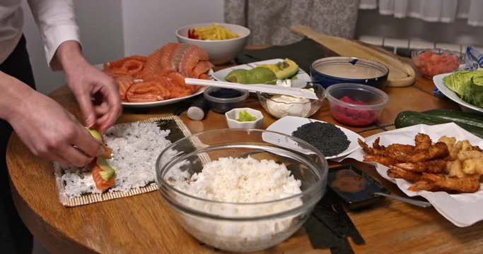 The sushi table. Woman making japanesse food