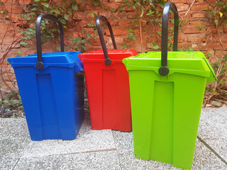 Red, green, blue garbage cans.