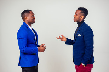 Two successful african american businessmen having communicating in studio white background