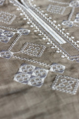 Obraz premium Embroidered linen shirt, white ornament, close