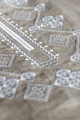 Embroidered linen shirt, white ornament, close