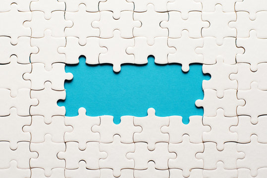 White details of puzzle on blue background and place for inscription - Powered by Adobe
