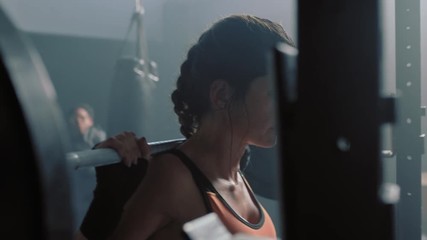 fitness woman bodybuilder using barbell weightlifting exercise strong female power lifting heavy weight resting exhausted in gym enjoying healthy lifestyle commitment