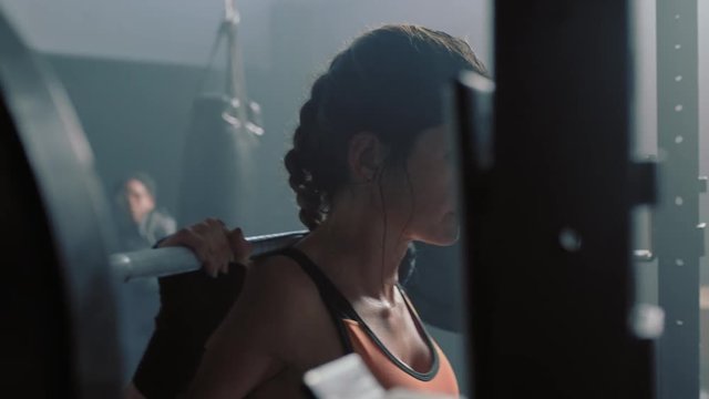 fitness woman bodybuilder using barbell weightlifting exercise strong female power lifting heavy weight resting exhausted in gym enjoying healthy lifestyle commitment