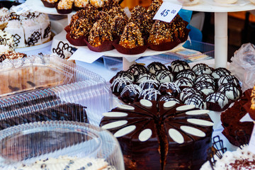 Variety of cakes on display at a market stall