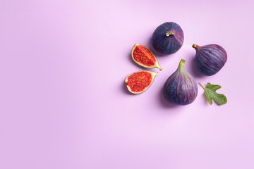 Fresh ripe figs on light background, top view. Space for text