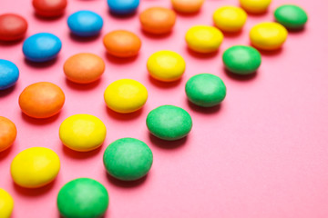 Tasty glazed candies on color background, closeup