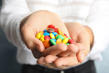 Woman holding many tasty glazed candies, closeup