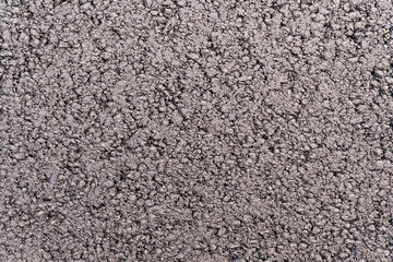 Surface grunge rough of asphalt, tarmac dark grainy road, top view
