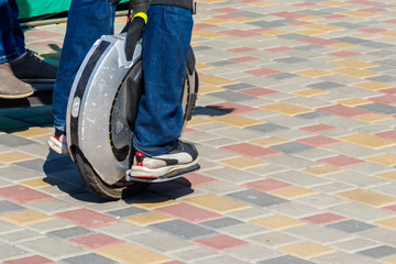 Electric unicycle. Man rides on mono wheel in park © olyasolodenko