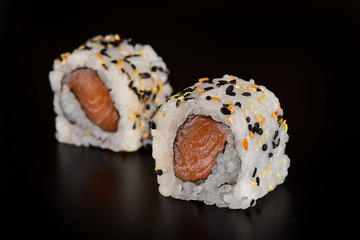 Salmon nigiri sushi isolated on black background
