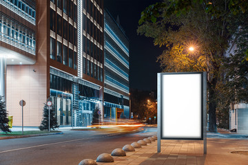 Blank white outdoor banner stand at night time in the city, 3d rendering.