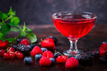 Drink from Berries in a glass cup, Decorated with Green Mint. Old dark Background. Superfoods and healthy lifestyle or detox diet food concept.