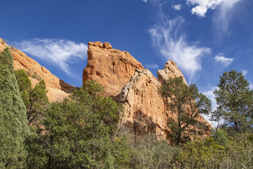 Garden of the Gods in Colorado Springs - huge red rock bluffs jut upwards against dramatic blue sky...