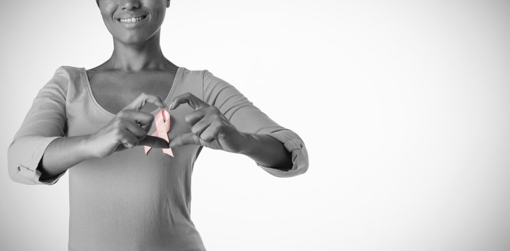 Smiling Women Wearing Pink Shirt Making Heart With Their Fingers