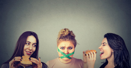 Chunky and slim women with fast food