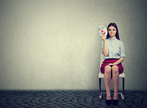 Nervous woman with clown mask before interview