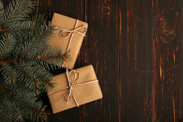 A gift from kraft paper, lies under the Christmas tree.